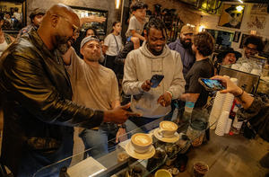 Guys taking a pictures of coffee